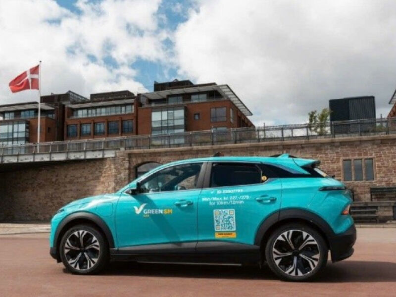 Bright cyan-colored VF6 taxi in Copenhagen.